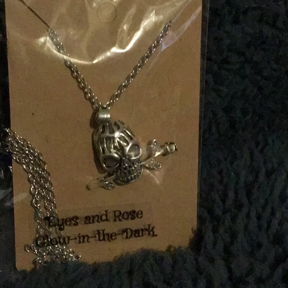 Beautifully handmade skulls and rose glow in the dark necklace